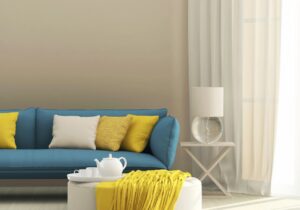 Condo living room with blue couch and yellow accent pillows in suburbs of knoxville tennessee